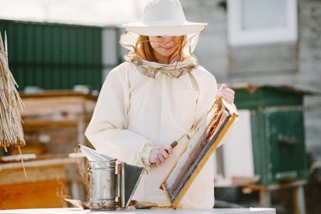 woman beekeeper sustainable gardening bee-friendly garden design